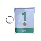 Number 1 flash card from ABC 26 set; green 1, apple illustration, 'One' text in plastic sleeve with ring.